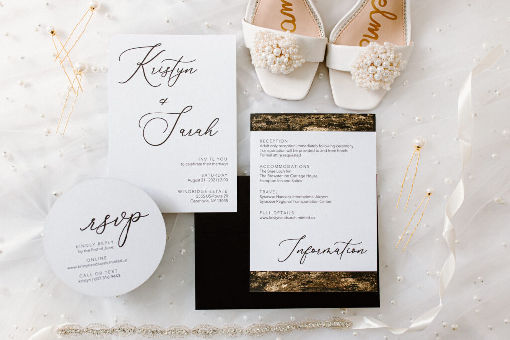 white black and gold invitation suite in a detailed flatlay
