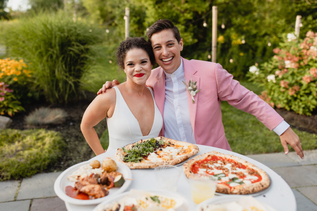 brides with a spread of food from food trucks including pizza and bbq