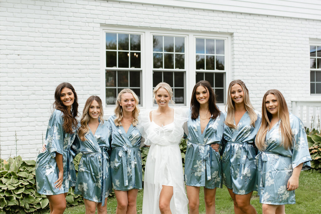 Bridal party getting ready in turquoise floral robes in Upstate New York