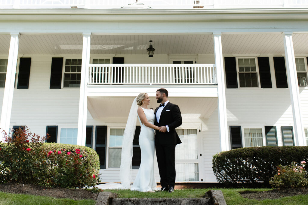bridal and groom portrait in front of historic white estate home in Upstate New York