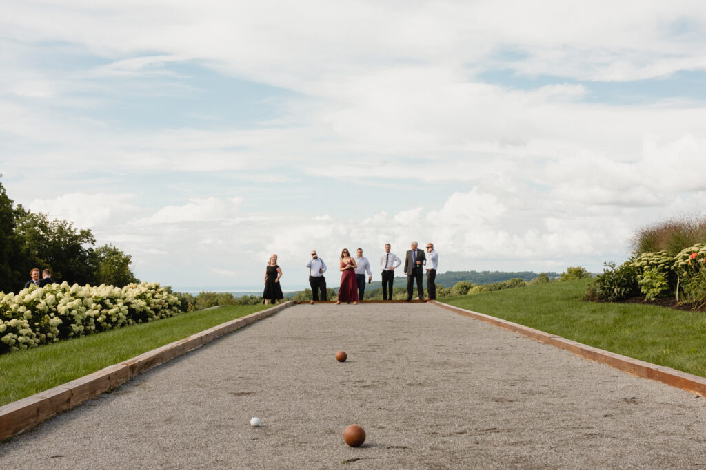 wedding guests play bocce ball outside at windridge estate