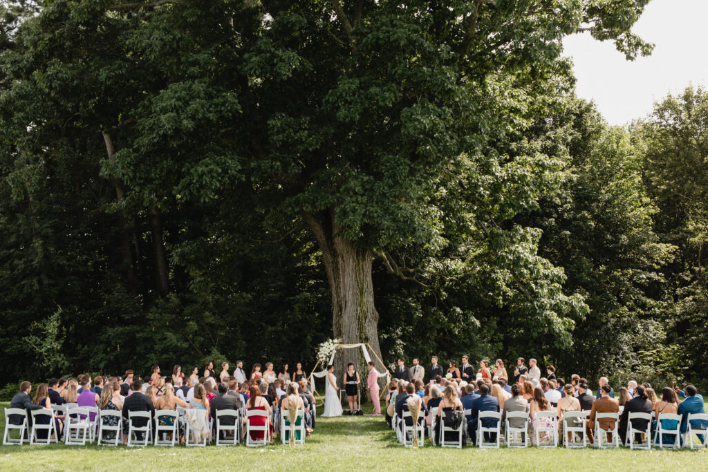 same sex outdoor ceremony under a large old oak tree upstate