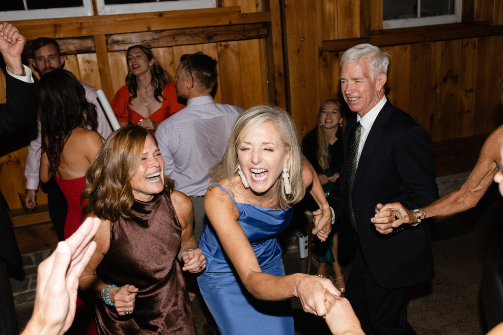 wedding guests laughing and dancing on the dancefloor 
