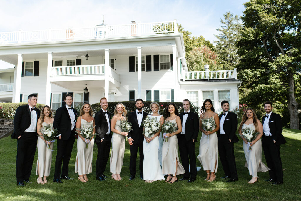elegant wedding party in front of a white estate house in Upstate New York 
