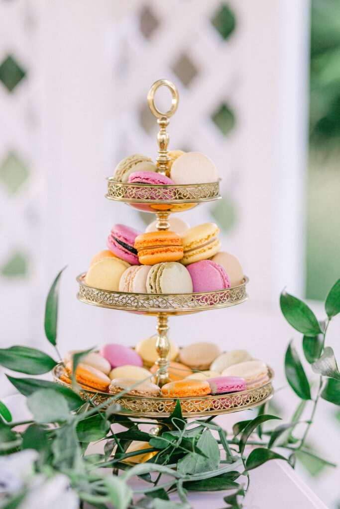 a gold tower of colorful French macarons sits in an outdoor gazebo at Windridge Estate