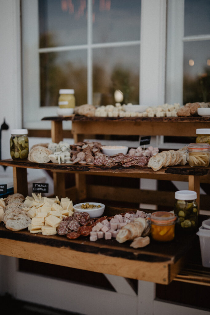 charcuterie display on wood risers for a summer camp themed wedding reception in upstate new york