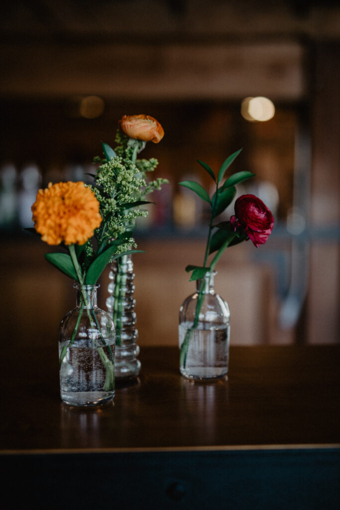 bud vases with colorful florals for wedding reception in upstate new york