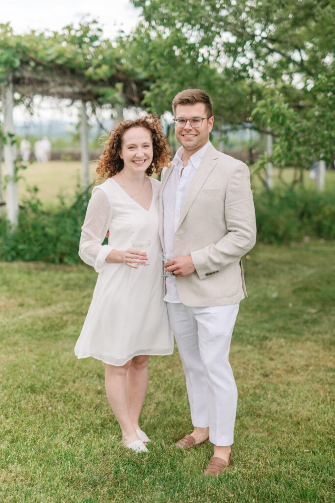 couple standing outside wearing all white 